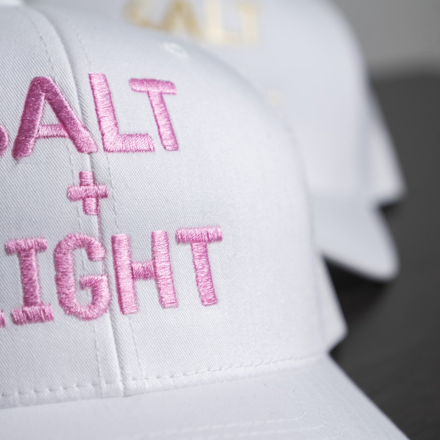 Side view of white trucker cap highlighting structured design and mesh ventilation