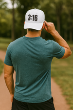 Man wearing a white Christian trucker cap backwards with '3:16' printed on the front panel.