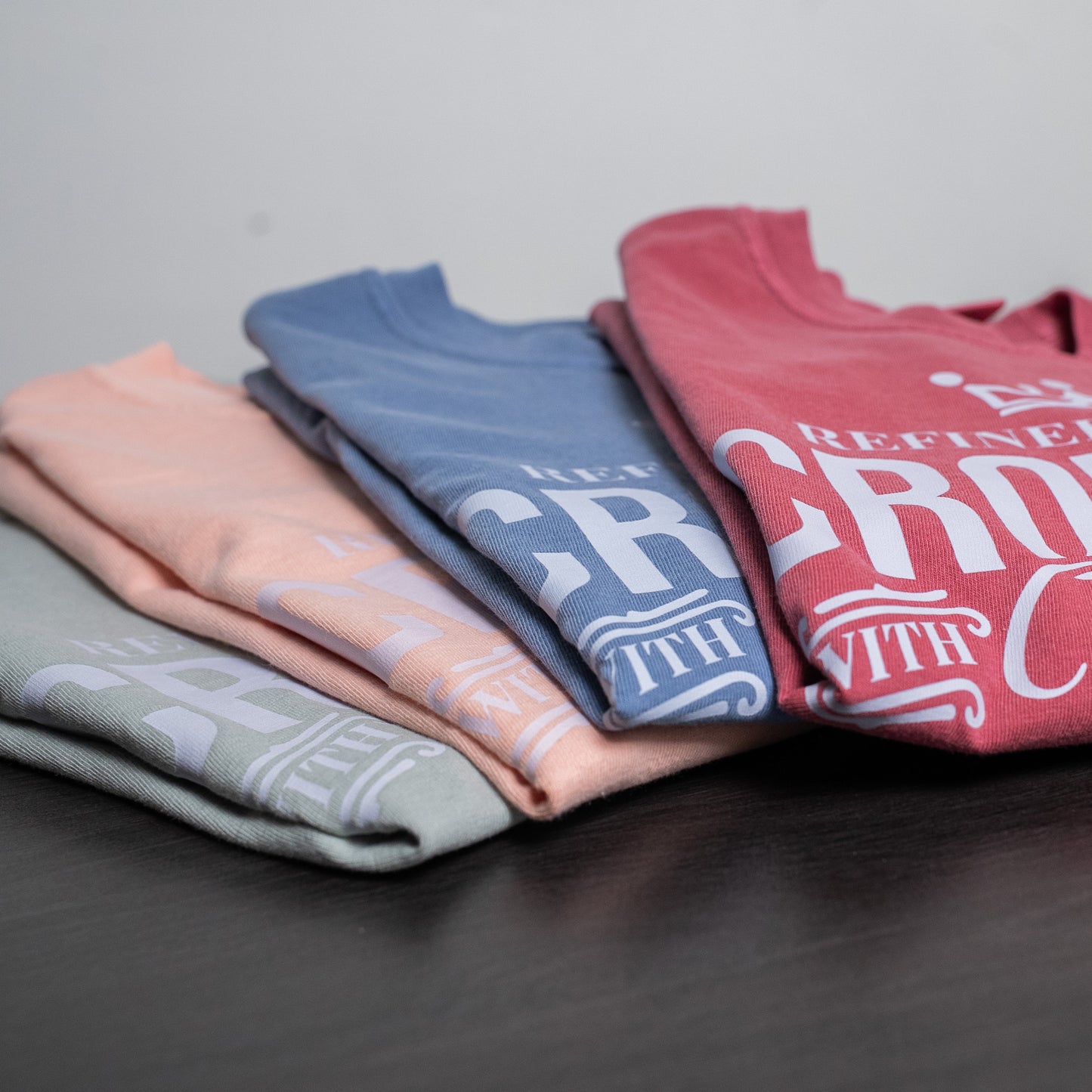 Women’s motivational t-shirt laid flat, highlighting the fabric texture and print detail  