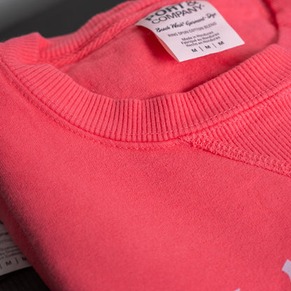 Salt + Light sweatshirt folded neatly on a wooden surface for display