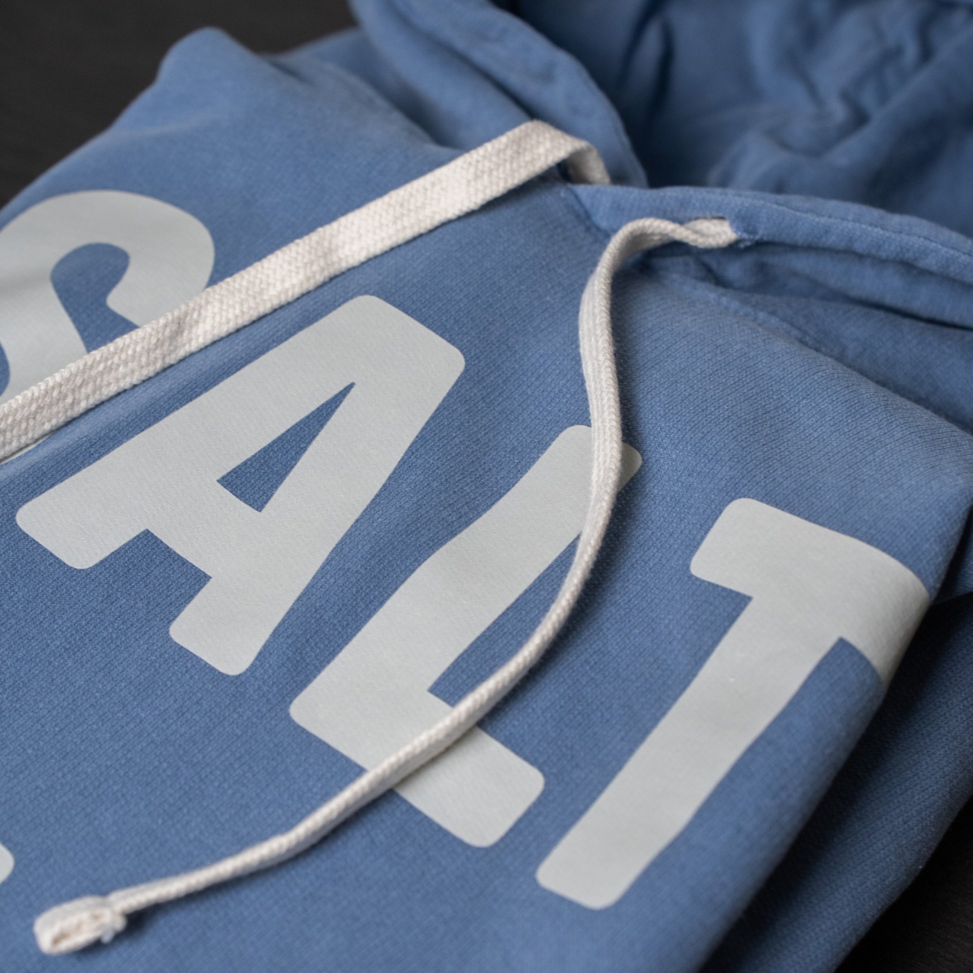 Folded SALT + LIGHT hoodie showcasing its quality stitching and design details