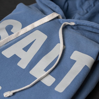 Folded SALT + LIGHT hoodie showcasing its quality stitching and design details