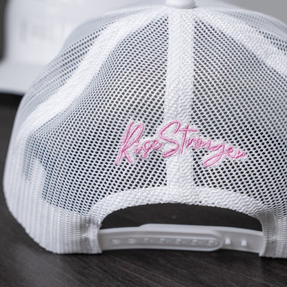 Close-up of pastel yellow embroidered lettering on white trucker cap front panel  