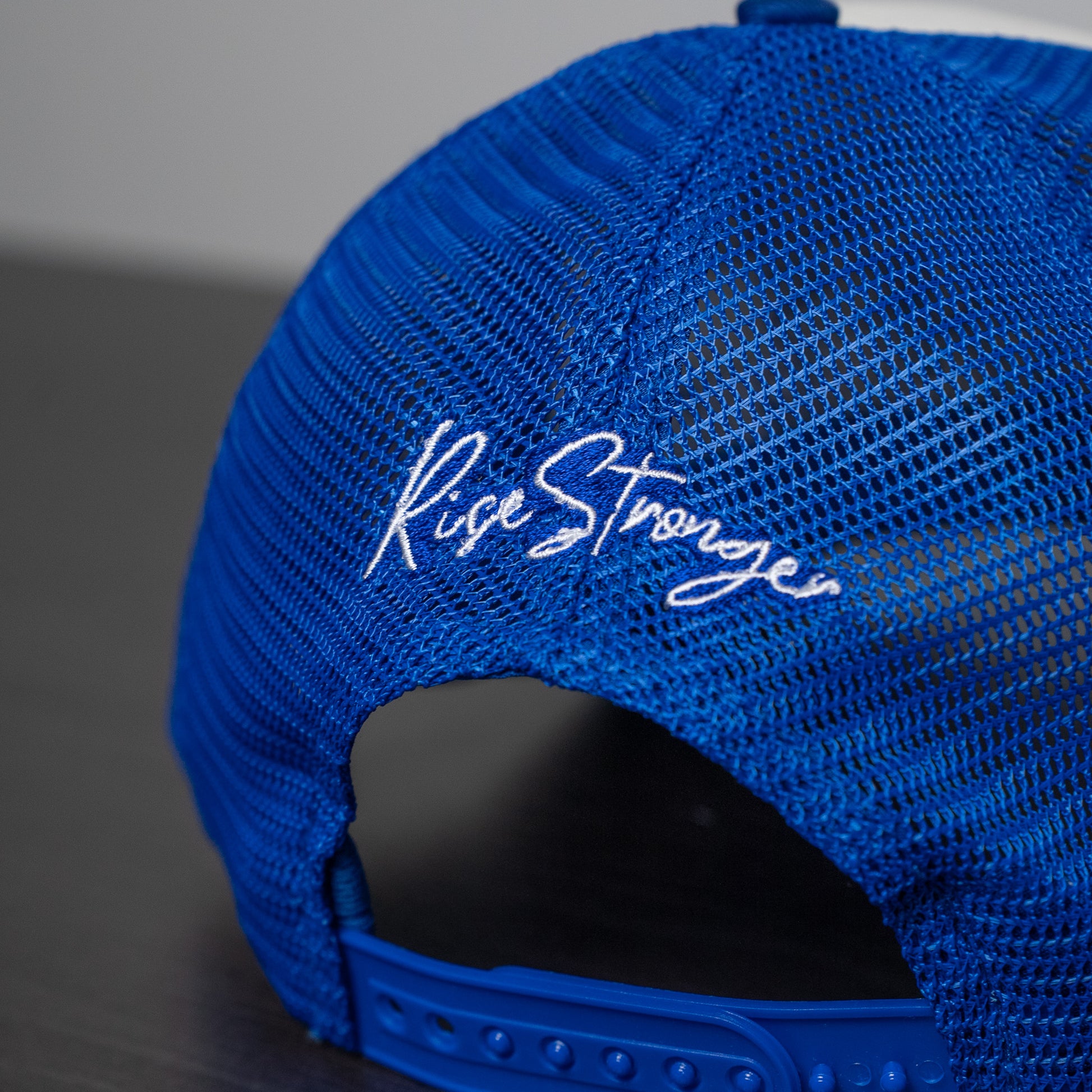 Adjustable snapback closure on pink and white trucker hat designed for a customizable fit  