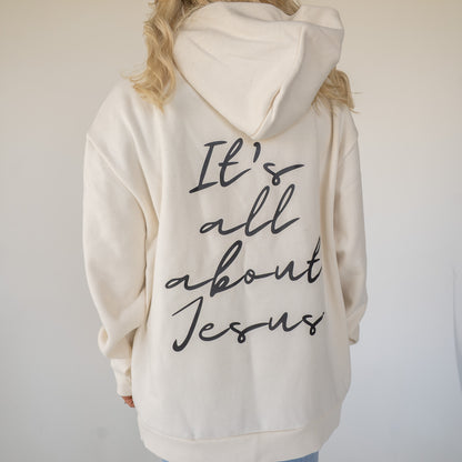 Unisex heavyweight fleece hoodie with “It’s All About Jesus” printed on the front  