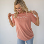Front view of a white Amazing Grace t-shirt with elegant script text on the chest  