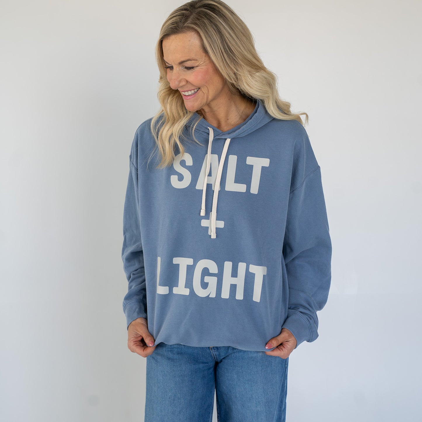 Close-up of bold SALT + LIGHT graphic on the back of the hoodie  