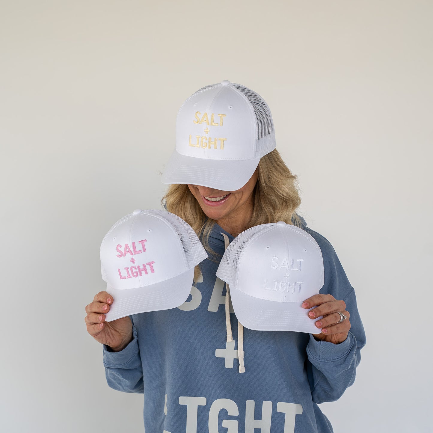 Adjustable white trucker hat showing breathable mesh panel and curved brim  