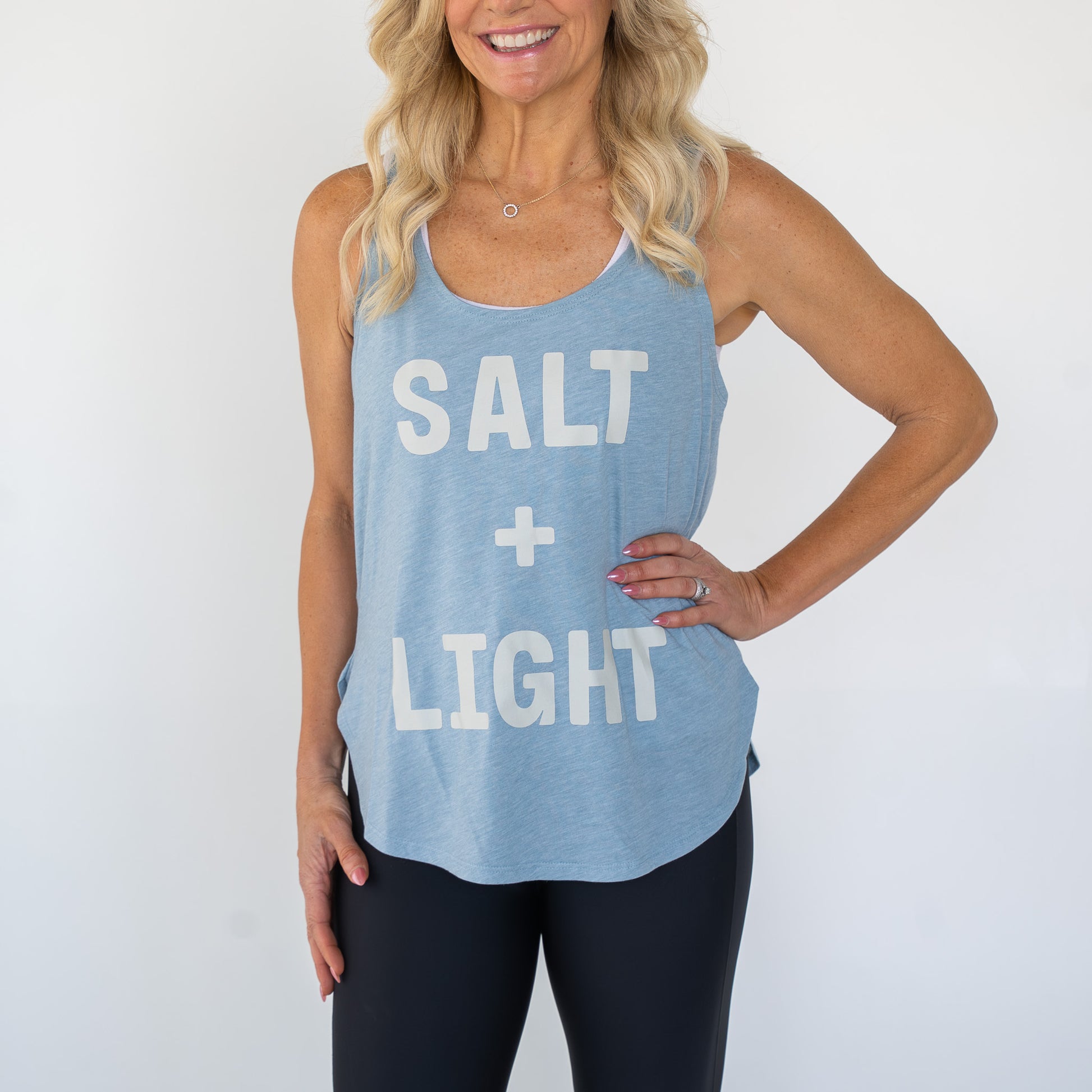 Women’s lightweight white tank top with SALT + LIGHT faith-inspired graphic on front  