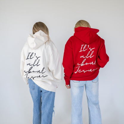 Model wearing oversized “It’s All About Jesus” hoodie in casual setting  