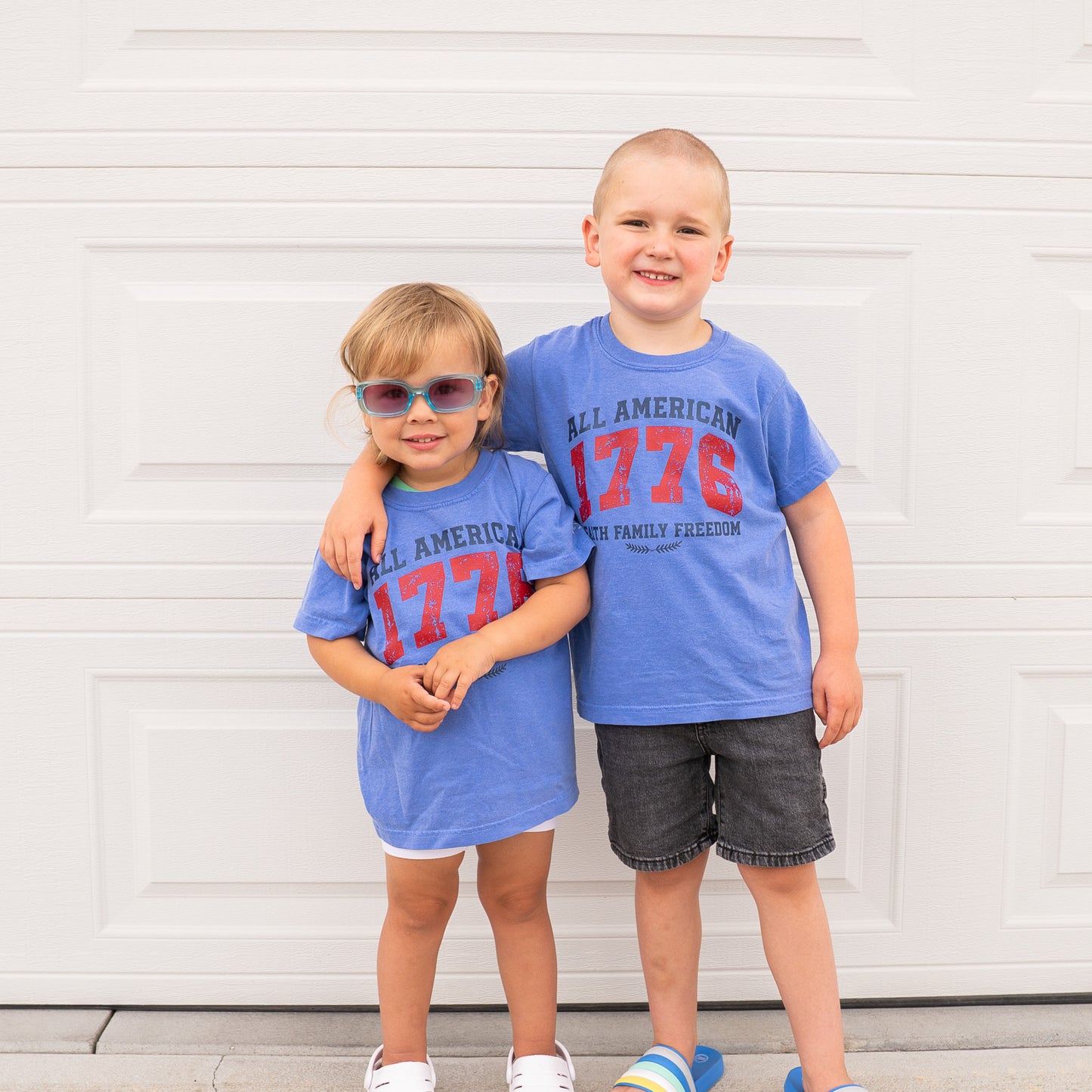 Front view of 1776 All American youth tee showing bold patriotic emblem and motivational scripture  