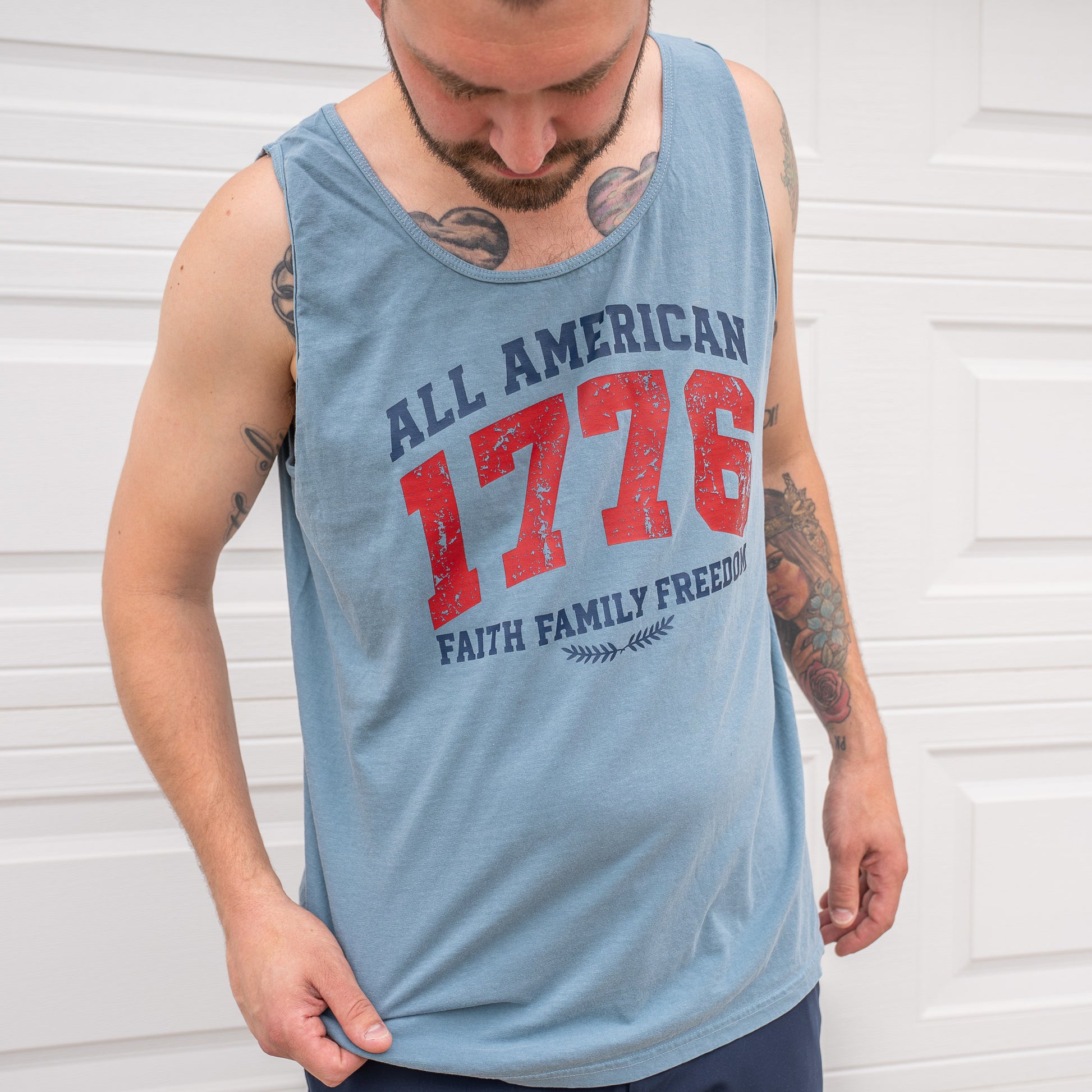 Folded 1776 All American tank top on surface showing tag and texture  