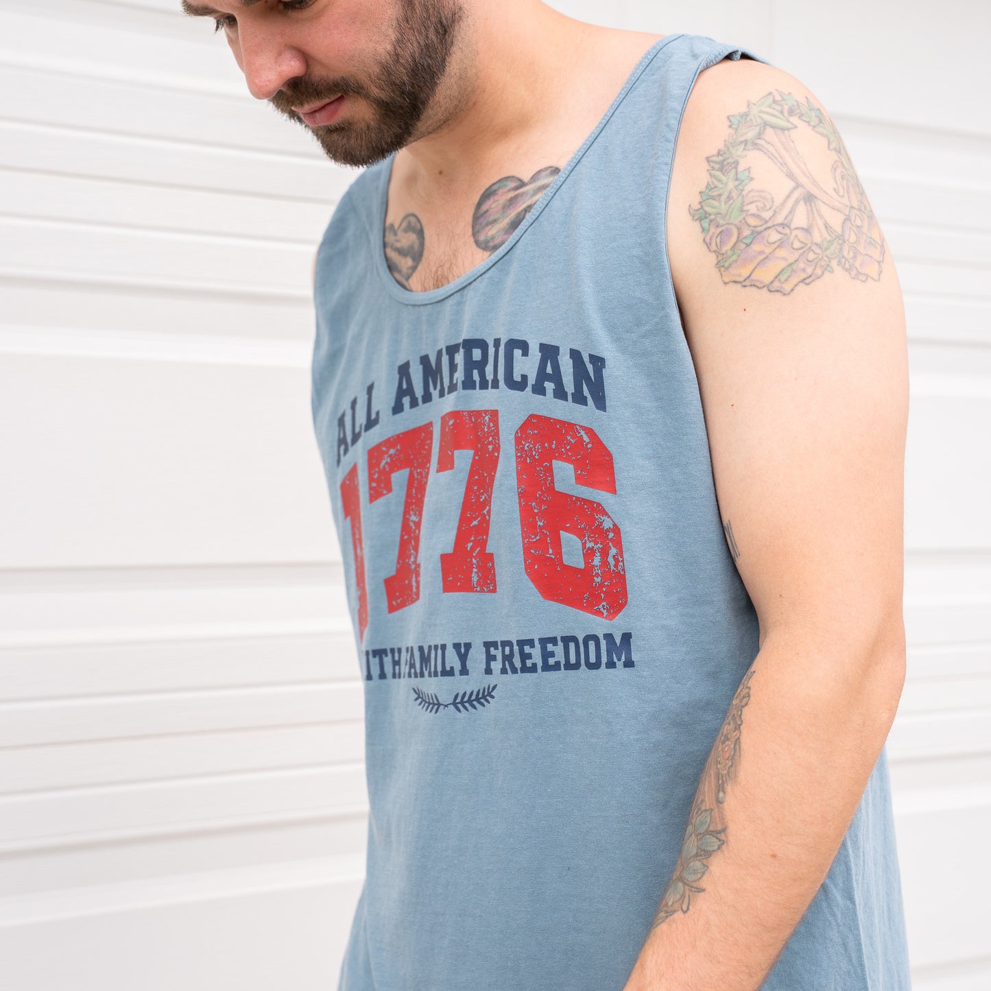 Model wearing patriotic sleeveless top outdoors in casual setting  
