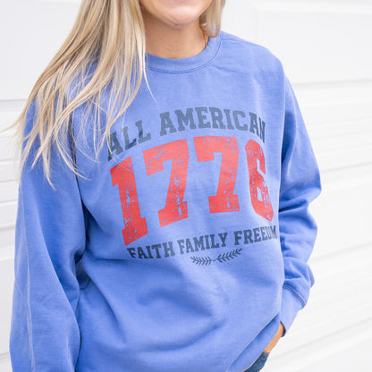 Woman wearing a 1776 All American crewneck sweatshirt in a casual outdoor setting  
