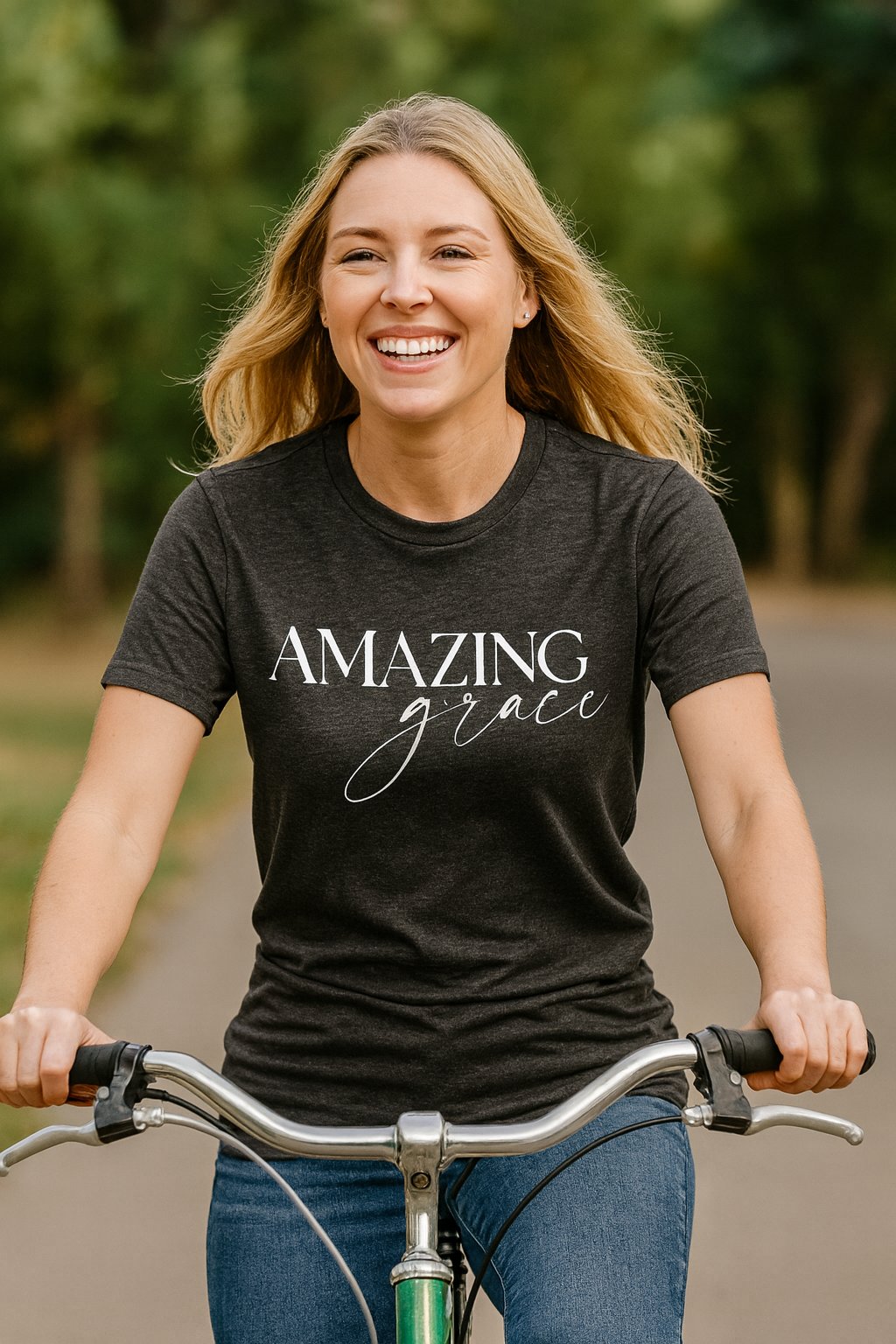 Woman riding a bike wearing a dark grey Christian t-shirt with 'Amazing grace' text.