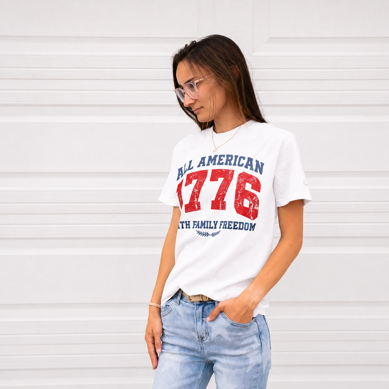 Woman wearing white 1776 All American t-shirt with red and navy print