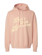 Peach colored Christian hoodie with text that reads 'Don't Stop Believing.'