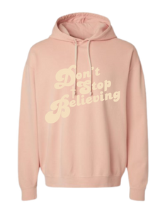 Peach colored Christian hoodie with text that reads 'Don't Stop Believing.'