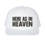 White cap with 'HERE AS IN HEAVEN' text 