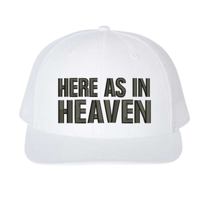 White cap with 'HERE AS IN HEAVEN' text 