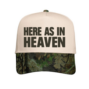 Natural / Mossy Oak hat with 'Here As In Heaven' text.