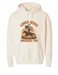Beige Christian patriotic hoodie with an American flag and text that reads Loves Jesus and America Too.