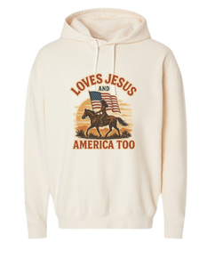 Beige Christian patriotic hoodie with an American flag and text that reads Loves Jesus and America Too.