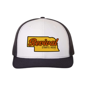 Blue/White trucker cap with 'Revival Starts Here' overlaying the state of Nebraska. 