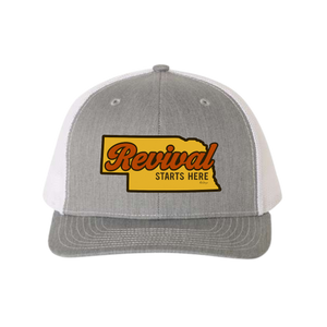 Grey trucker cap with 'Revival Starts Here' overlaying the state of Nebraska. 