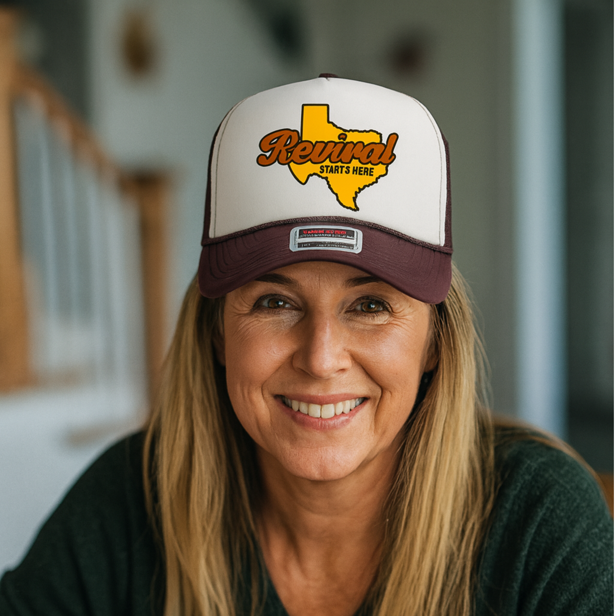 Woman wearing a cap with 'Revival Starts Here' Texas design