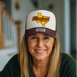 Woman wearing a cap with 'Revival Starts Here' Texas design