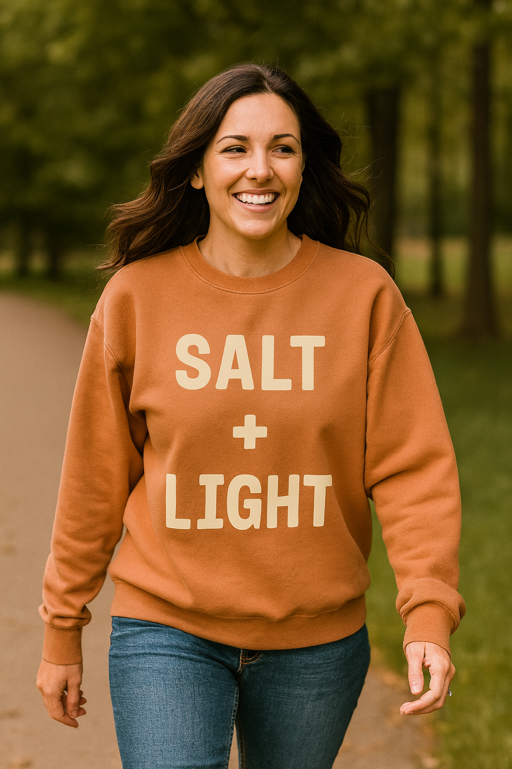 Christian woman wearing a 'SALT + LIGHT' crewneck sweatshirt.