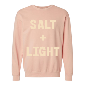 Peach colored 'SALT + LIGHT' crewneck sweatshirt.