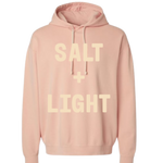 Peach colored Christian hoodie with 'Salt + Light' text on the front in cream color.