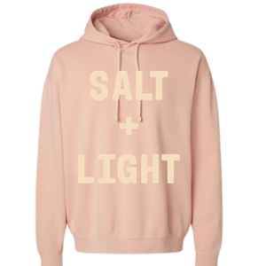 Peach colored Christian hoodie with 'Salt + Light' text on the front in cream color.