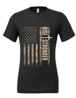 Christian Patriotic tee in dark grey with tattered American flag, a cross and Rise Stronger text on the front in cream color.
