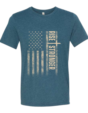 Christian Patriotic tee in steel blue with tattered American flag, a cross and Rise Stronger on the front in cream color.