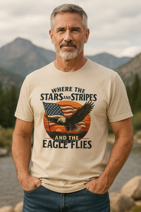Man wearing a cream colored Christian & patriotic t-shirt with 'Where the Stars & Stripes and Eagle Flies' on the front. 