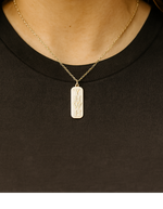 A gold trimmed Christian pendant necklace engraved with 'YHWH'.